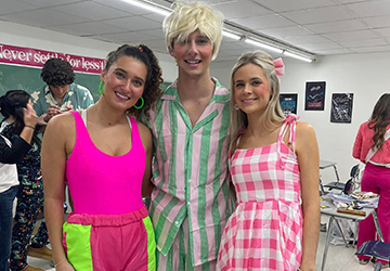 Three students dressed for a spirit day