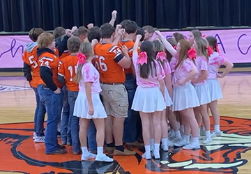 Students huddling together during a pep rally