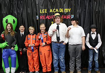 Students posing with ribbons from the Lee Academy Reading Fair