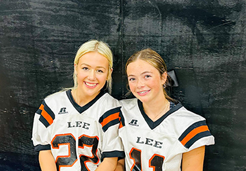 Two girls dressed in football attire